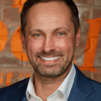 Ryan Waller, Guelph REALTOR®, smiling portrait against a textured background, representing expertise in local real estate services.